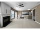 Open-plan living room featuring a fireplace, ceiling fan, and connection to kitchen at 9139 Hearst Ct, Charlotte, NC 28269