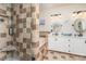 Bathroom with shower, tub, double sinks, white cabinets, and tiled walls and floors at 919 42Nd Avenue Ne Ln, Hickory, NC 28601