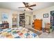 Well-lit bedroom with carpet flooring, dresser, bookcase, and ensuite bath with double sinks at 919 42Nd Avenue Ne Ln, Hickory, NC 28601