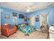 Blue bedroom with a cozy bed, stuffed animals, and a striped chair, creating a fun and inviting space at 919 42Nd Avenue Ne Ln, Hickory, NC 28601
