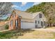 Two-story home with brick accents, large garage and a basketball hoop in the driveway at 919 42Nd Avenue Ne Ln, Hickory, NC 28601