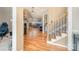 Inviting foyer with hardwood floors, staircase, and open view to the living room with a fireplace at 919 42Nd Avenue Ne Ln, Hickory, NC 28601
