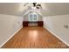 Finished attic space with hardwood floors, a built-in desk, and natural light, ideal for a home office at 9501 Brighthaven Ln, Charlotte, NC 28214