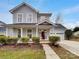 Charming two-story home with a welcoming front porch and well-maintained landscaping at 9501 Brighthaven Ln, Charlotte, NC 28214