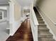 Hallway with stairs and hardwood flooring, leading to the kitchen at 9501 Brighthaven Ln, Charlotte, NC 28214