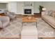 Bright living room featuring a fireplace, neutral tones, and stylish, comfortable furnishings at 9501 Brighthaven Ln, Charlotte, NC 28214