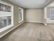 Bright living room with carpet, large windows, and neutral paint, offering a welcoming space at 9501 Brighthaven Ln, Charlotte, NC 28214