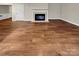 Living room featuring hardwood flooring and a fireplace with a white mantel at 9501 Brighthaven Ln, Charlotte, NC 28214