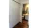 View into a well-lit bathroom from the hallway, featuring matching vanity and storage at 9734 Kennerly Cove Ct, Charlotte, NC 28269