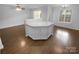 Kitchen island with white cabinets and countertop in an open-concept kitchen at 9930 Birch Knoll Ct, Charlotte, NC 28213