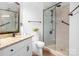 Bright bathroom featuring a granite countertop vanity and a tiled walk-in shower at 1107 Torrence Cir, Davidson, NC 28036