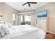 Bedroom featuring hardwood floors, a sliding door, and a mounted TV at 1107 Torrence Cir, Davidson, NC 28036