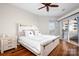 Cozy bedroom with a large window, ceiling fan, and access to the balcony at 1107 Torrence Cir, Davidson, NC 28036