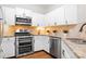 Modern kitchen equipped with stainless steel appliances, granite countertops, and ample cabinet space at 1107 Torrence Cir, Davidson, NC 28036