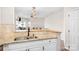 Functional kitchen showcasing granite countertops, stainless steel sink, and breakfast bar at 1107 Torrence Cir, Davidson, NC 28036
