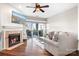 Inviting living room featuring a cozy fireplace, ceiling fan, and sliding glass doors to the balcony at 1107 Torrence Cir, Davidson, NC 28036