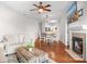 Open-concept living space featuring a fireplace, ceiling fan, and seamless flow to the dining area at 1107 Torrence Cir, Davidson, NC 28036