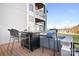 View of an outdoor patio area with a high top table and seating overlooking the lake at 1107 Torrence Cir, Davidson, NC 28036