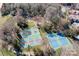 Aerial view of tennis and pickleball courts surrounded by trees at 1107 Torrence Cir, Davidson, NC 28036