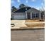 Charming single-Gathering home with two-car garage, gray siding, and professionally landscaped front yard at 1429 Nia Rd, Charlotte, NC 28215