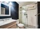 Modern bathroom with a glass-enclosed shower and stylish black and white design at 1700 Logie Ave, Charlotte, NC 28205