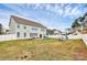 Spacious backyard featuring a patio with outdoor seating, a grill, and a play area, enclosed by a white fence at 2408 Napa Ter, Clover, SC 29710