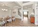Bright dining room boasts modern chandelier, coffered ceilings, and open access to the living room and entry hall at 2408 Napa Ter, Clover, SC 29710
