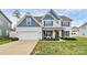 Charming two-story home with white siding, blue accents, a well-maintained lawn, and an attached two-car garage at 2408 Napa Ter, Clover, SC 29710