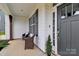Cozy front porch featuring wicker chairs and a view of the home's modern exterior and entryway at 2408 Napa Ter, Clover, SC 29710