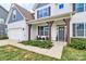 Inviting front porch with dark wood columns and two wicker chairs in front of a modern white home at 2408 Napa Ter, Clover, SC 29710