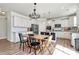 Bright kitchen featuring white cabinets, stainless steel appliances, an island, and a view of the dining area at 2408 Napa Ter, Clover, SC 29710