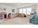 Bright playroom featuring a comfortable sectional sofa, patterned rug, and large windows at 2408 Napa Ter, Clover, SC 29710