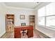 Bright office space offers ample natural light, built-in shelving, and room for a comfortable workspace at 2408 Napa Ter, Clover, SC 29710