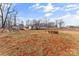 Wide shot of property highlighting a playground set, storage shed, wooded backdrop, and spacious backyard at 255 Liberty Estates Ln, Taylorsville, NC 28681