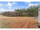 Spacious backyard features a play structure and shed, backed by dense woodlands at 255 Liberty Estates Ln, Taylorsville, NC 28681