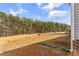 Expansive backyard featuring a shed, play structure and bordered by lush trees offering privacy at 255 Liberty Estates Ln, Taylorsville, NC 28681