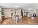 Inviting dining area featuring a wooden table, white chairs, and seamlessly connecting with a modern kitchen at 255 Liberty Estates Ln, Taylorsville, NC 28681