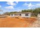 Inviting single-story house features a cozy porch and a lush, expansive yard perfect for relaxation and outdoor enjoyment at 255 Liberty Estates Ln, Taylorsville, NC 28681