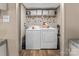 Practical laundry room with modern appliances and storage shelves at 255 Liberty Estates Ln, Taylorsville, NC 28681