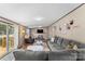Bright living room featuring a gray sectional sofa, modern lighting and hardwood floors at 255 Liberty Estates Ln, Taylorsville, NC 28681