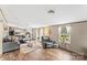 Open-concept living area with hardwood floors, gray sectional sofa, and modern decor at 255 Liberty Estates Ln, Taylorsville, NC 28681