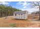 Backyard featuring a sturdy storage shed with double doors and a play structure nearby at 255 Liberty Estates Ln, Taylorsville, NC 28681
