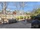 Charming back yard featuring a patio area with a picnic table, and mature landscaping at 6816 Charter Hills Rd, Charlotte, NC 28277