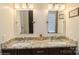 Bright bathroom featuring a dual-sink vanity with granite countertop and updated fixtures at 6816 Charter Hills Rd, Charlotte, NC 28277