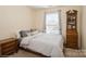 Well-lit bedroom featuring a large window, modern decor, and natural light at 6816 Charter Hills Rd, Charlotte, NC 28277