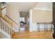 Bright foyer featuring hardwood floors, a staircase, and an open view to the living spaces at 6816 Charter Hills Rd, Charlotte, NC 28277