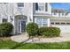 Inviting entryway with a clear glass door, decorative shrubbery, and a 'Welcome' sign at 6816 Charter Hills Rd, Charlotte, NC 28277