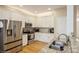 Close up of a modern kitchen with stainless steel appliances and granite countertops at 6816 Charter Hills Rd, Charlotte, NC 28277