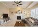 Inviting living room with a decorative fireplace, comfortable seating, and plenty of natural light at 6816 Charter Hills Rd, Charlotte, NC 28277