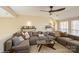 Cozy living room with large sectional sofa and a ceiling fan at 6816 Charter Hills Rd, Charlotte, NC 28277